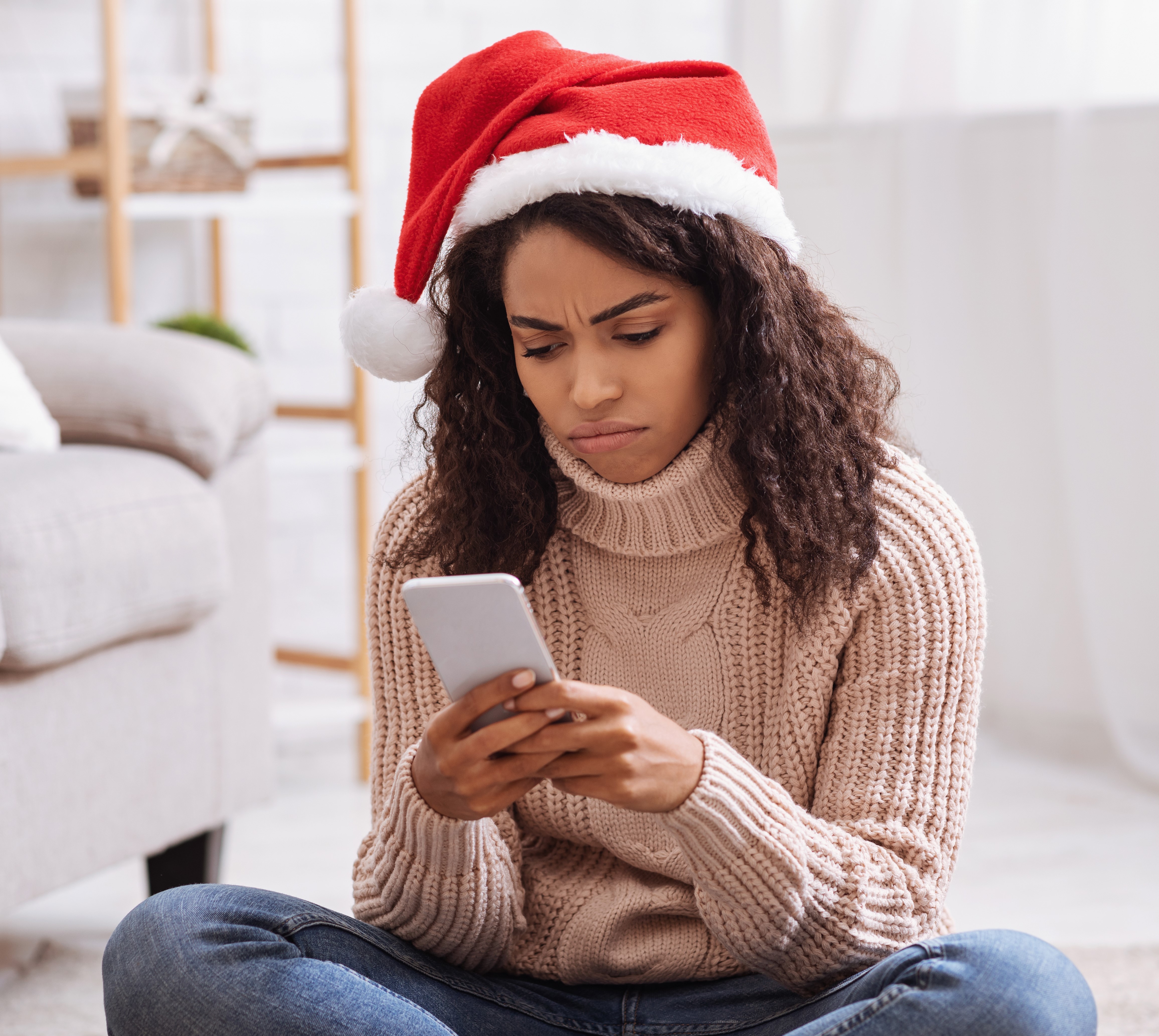 Woman with Santa hat on phone